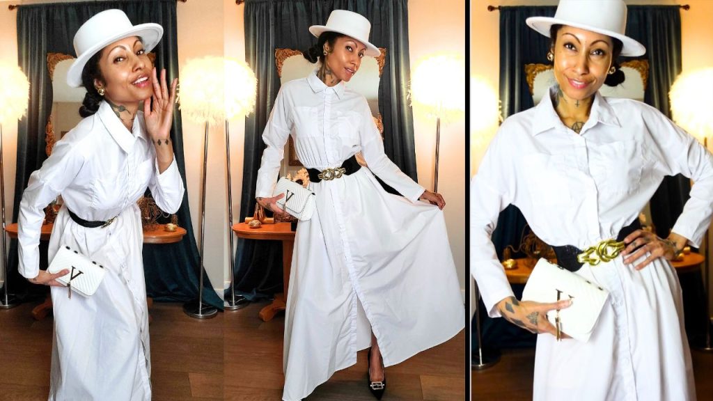  An elegant woman donning a white dress and hat, reminiscent of Valentino's fashion, radiates timeless beauty