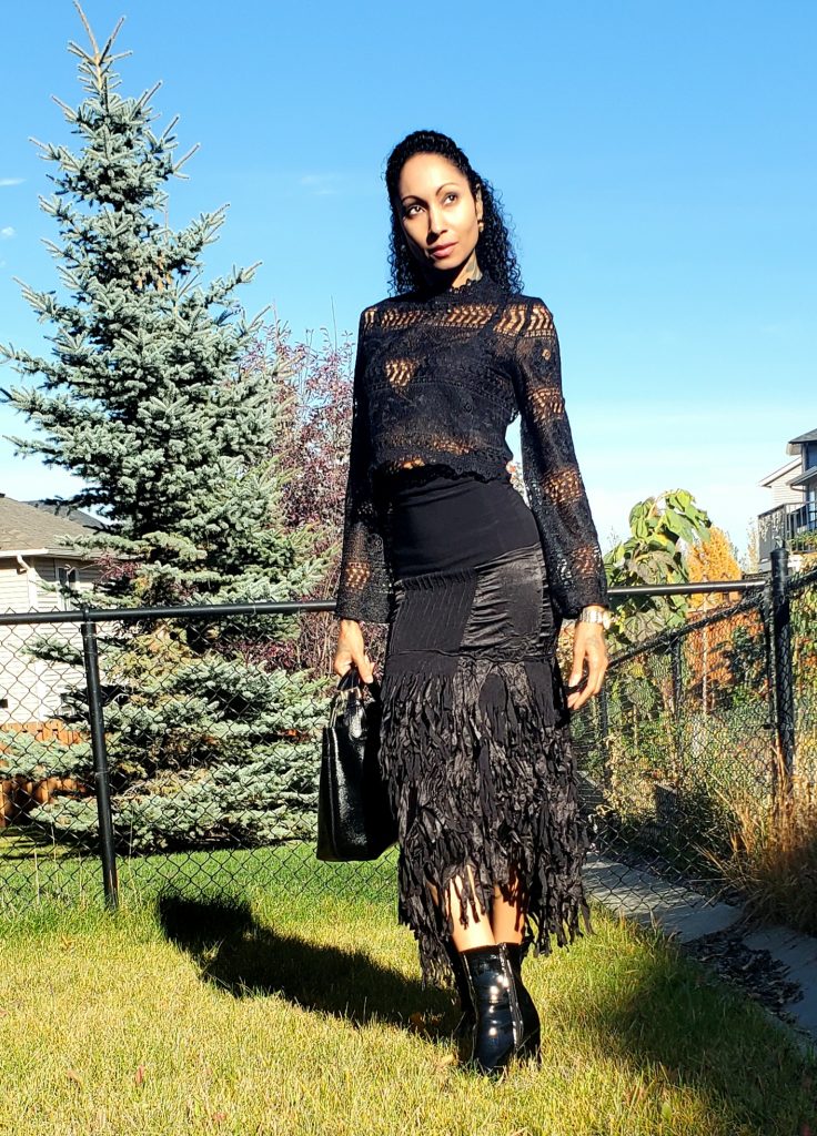 Elegant woman in 1990s black satin ankle-length skirt with mixed textiles
