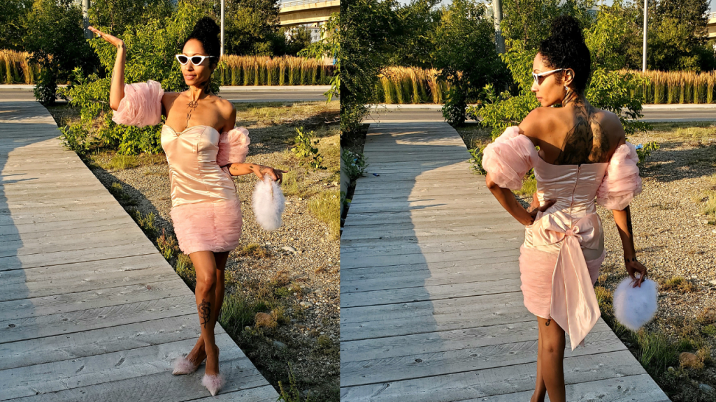  Luxurious woman in pink vintage bow dress, radiating femininity, styled with chic fur heels.