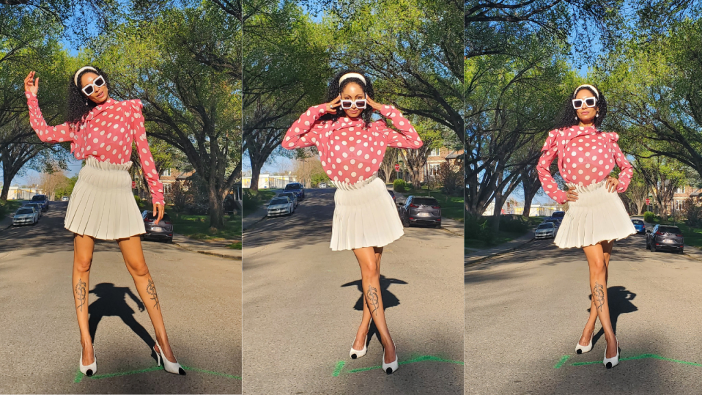  A chic woman exudes elegance in a pink polka dot chiffon blouse, paired flawlessly with a pleated tennis skirt.